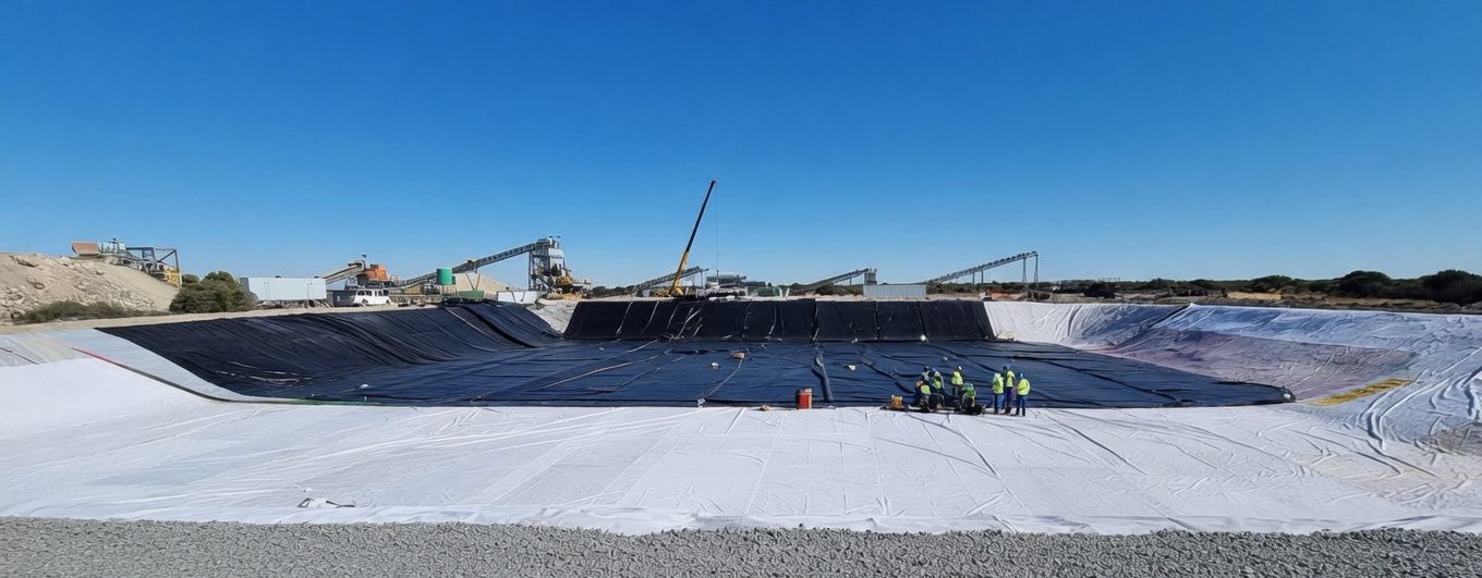 Custom-made dam liner holding water on a farm